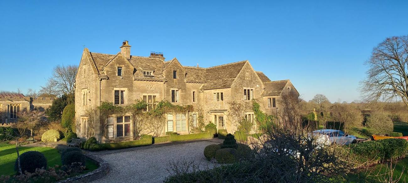 Cotswold stone manor house from the garden