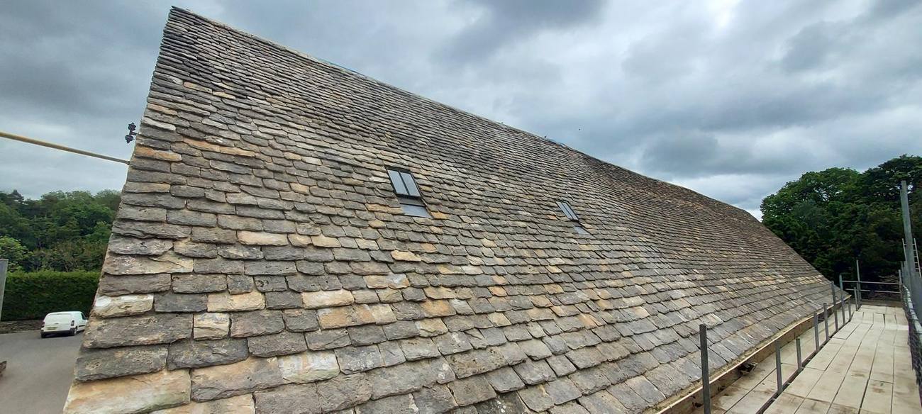 Cotswold stone slate roof with rooflight