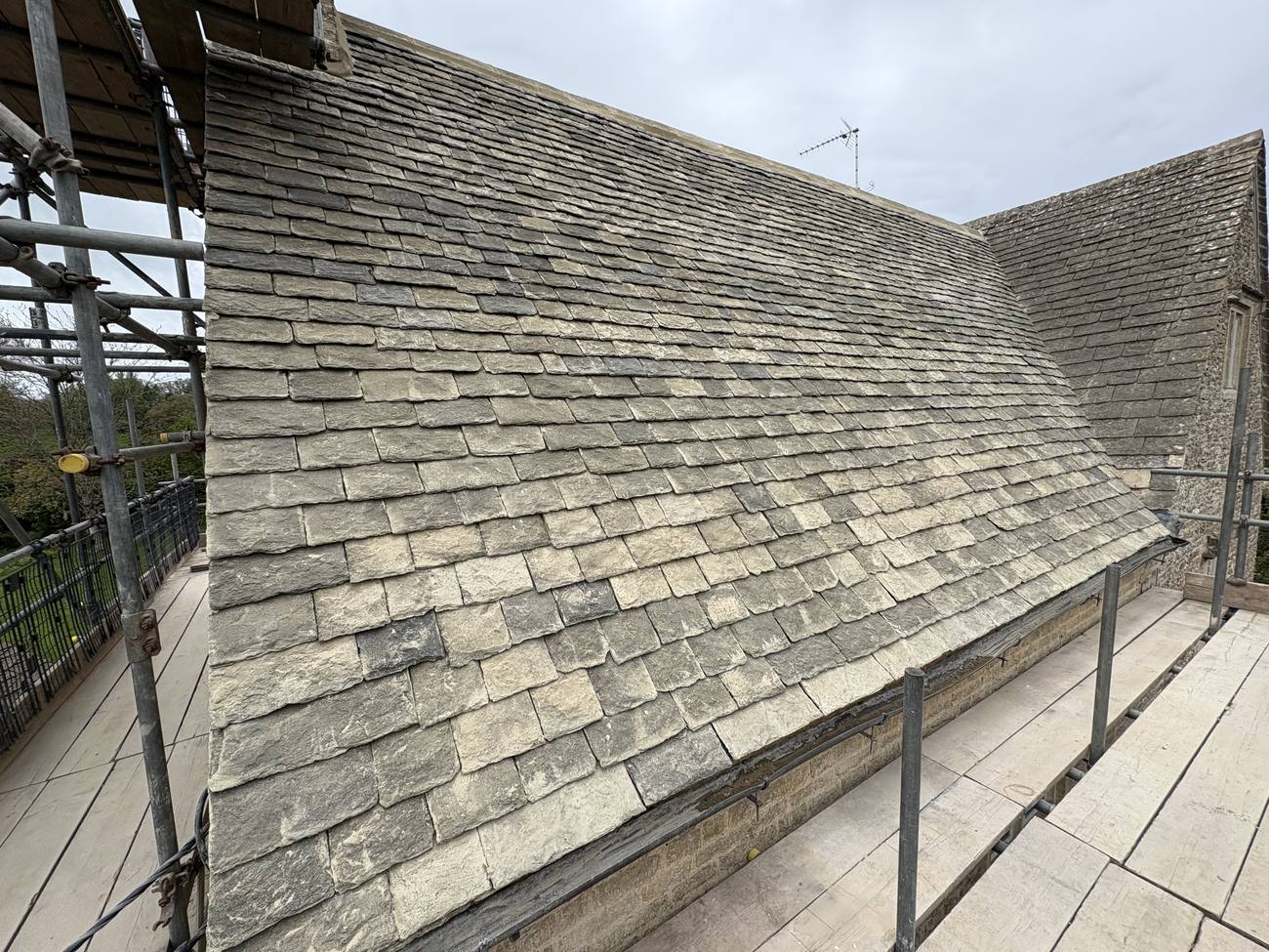 Weathered Cotswold stone roof, close ridge detail