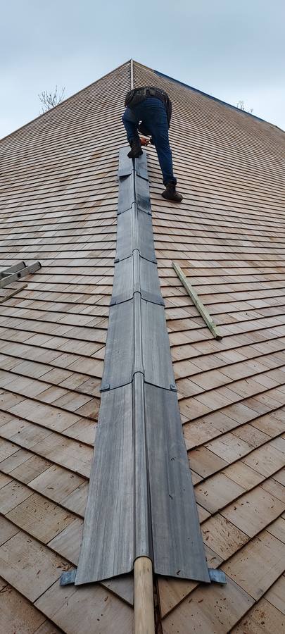 Fitting lead ridge flashing on a cedar shingle roof
