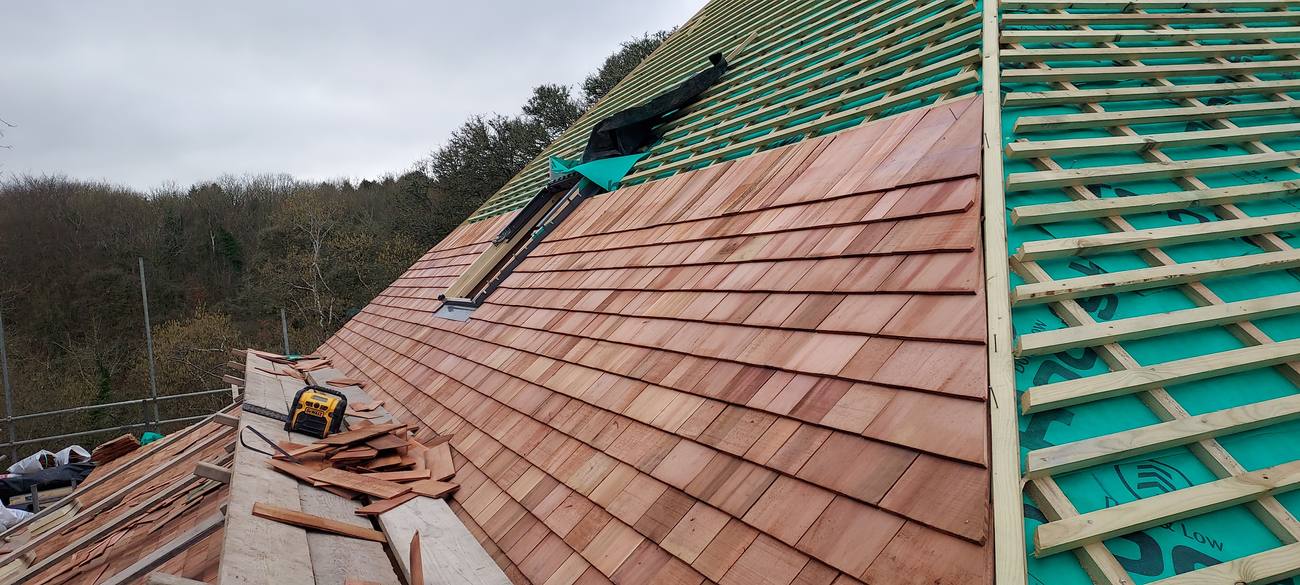 Cedar shingle roof installation in progress