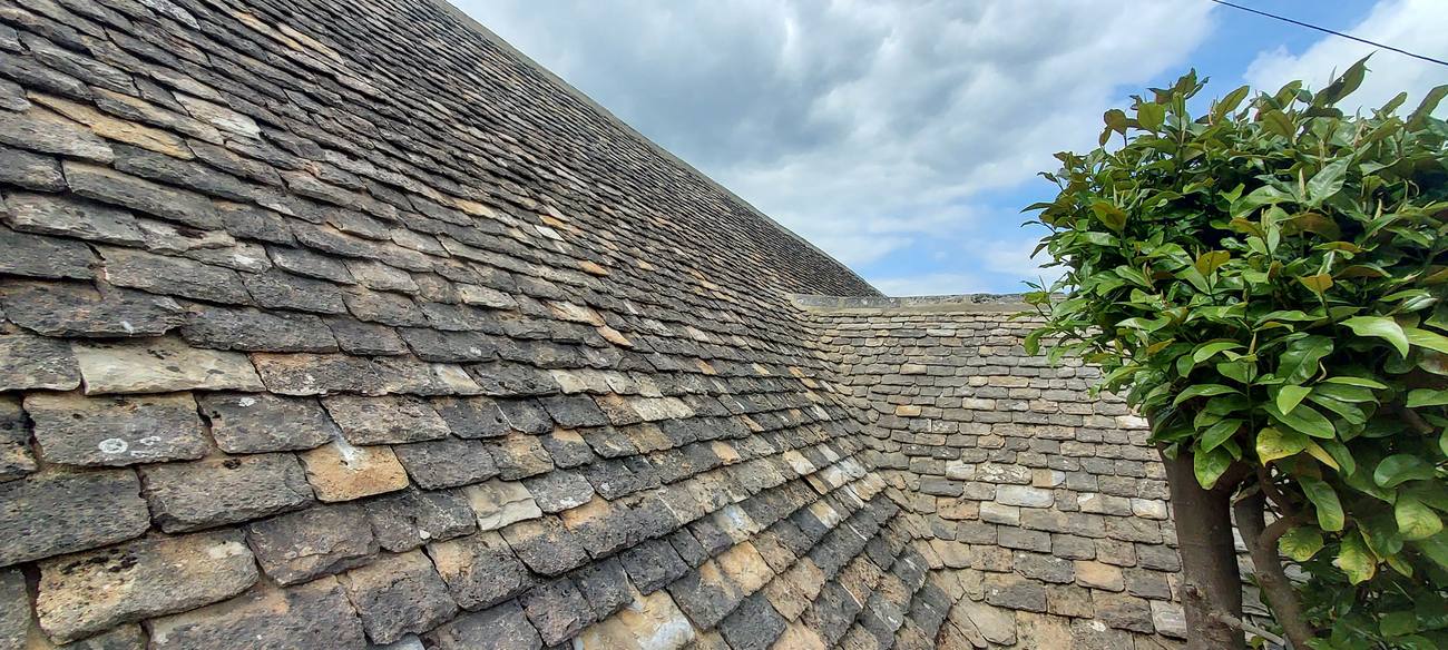 Cotswold stone roof with swept valley
