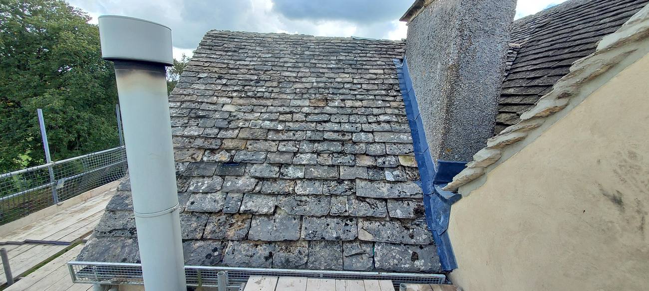 Chimney lead flashing on a Cotswold stone roof